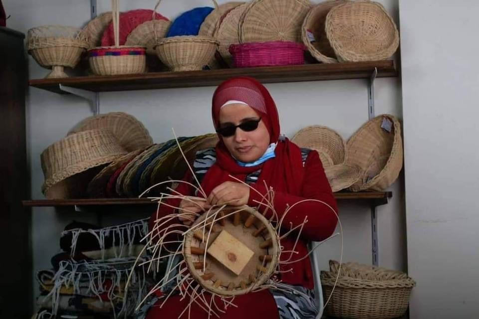 Visually impaired artisans working on a bamboo basket